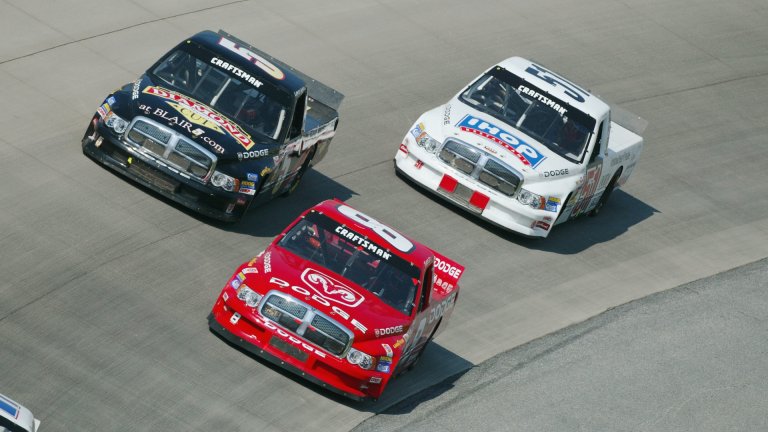 DOVER DOWNS, DE - MAY 31: Bill Lester drives his #8 Dodge Motorsports Dodge Ram ahead of the #5 of Lance Hooper and the #51 of Michael Ritch on May 31, 2002 during the NASCAR Craftsman Truck Series MBNA America 200 at Dover International Speedway in Dover Downs, Delaware. (Photo By Robert Laberge/Getty Images)
