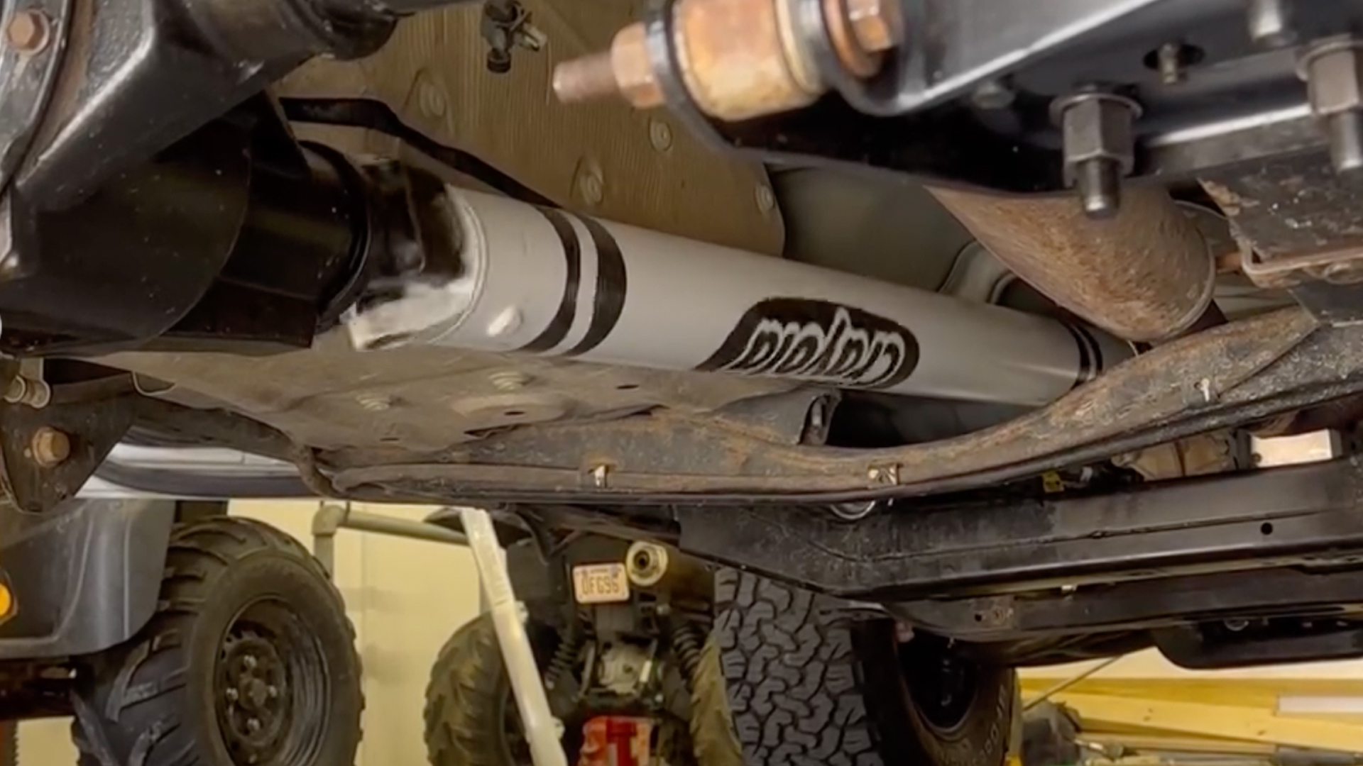 A pickup truck's driveshaft painted to look like a crayon