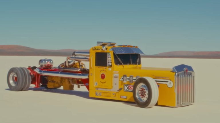 A modified Kenworth W-Series semi-truck sits on the salt flats.